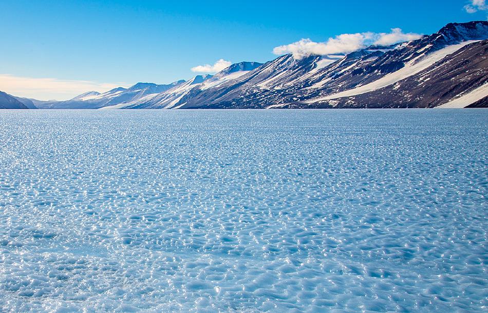 Ein Beispiel eines Gebiets mit blauem Eis, wo altes, tiefliegendes Eis an die OberflÃ¤che gezwungen wird und der Wind die obersten Eisschichten wegtrÃ¤gt, wÃ¤hrend die Sonnenstrahlung ein Muster ins Eis schmilzt. Bild: Katja Riedel